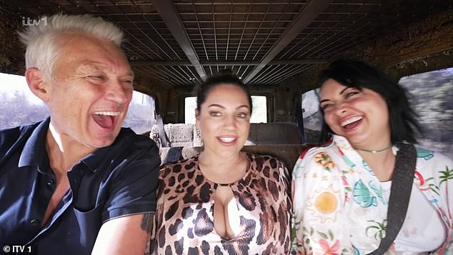 The English model donned a very plunging animal-print jumpsuit displaying her ample assets - although it didn't turn out to quite a suitable item to fight off disgusting critters in the horrifying trial (pictured with Shona McGarty and Martin Kemp)