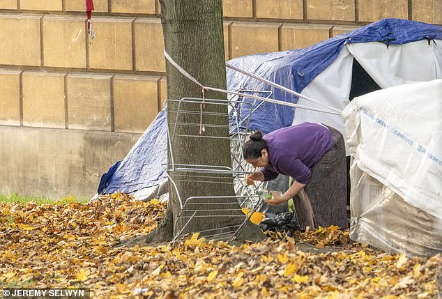 Dozens of Eastern European and African migrants are living in tents on a tiny strip of greenery