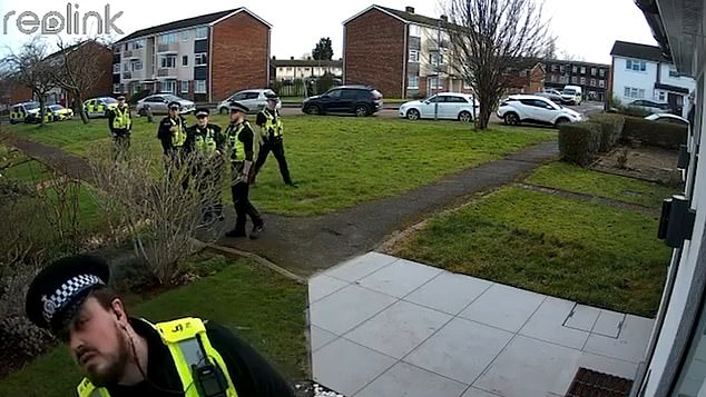 CCTV shows six uniformed police officers descending on their suburban home before they were led away in front of their crying daughter in January