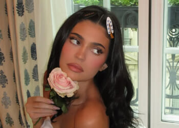 Kylie Jenner goes naked in bed as she holds a pink rose in 'cute' candid photos
