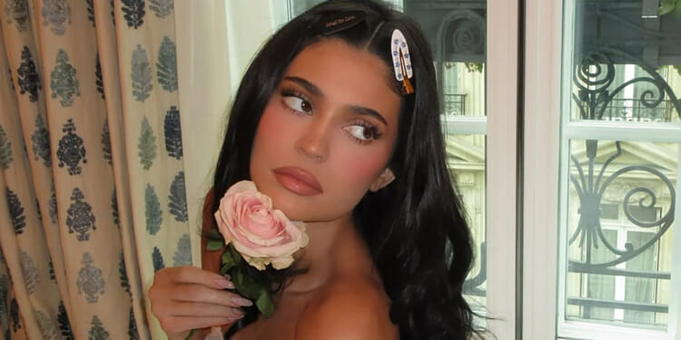 Kylie Jenner goes naked in bed as she holds a pink rose in 'cute' candid photos