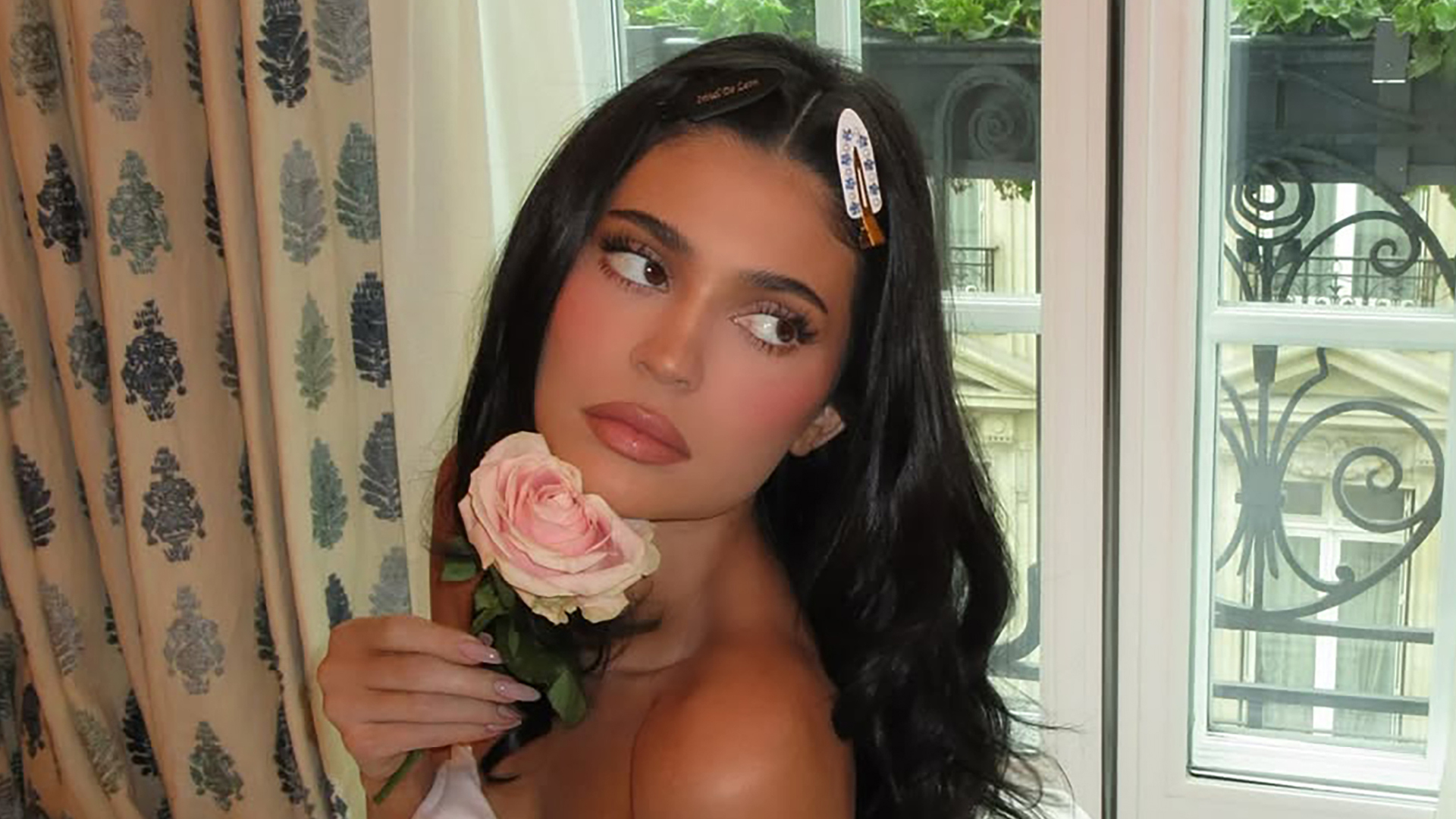 Kylie Jenner goes naked in bed as she holds a pink rose in 'cute' candid photos