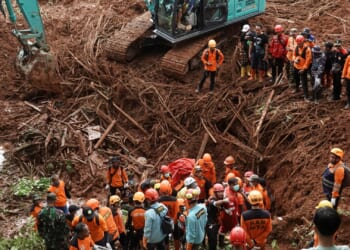 Landslide kills 18 as hundreds of rescuers desperately search through dense jungle for dozens more missing