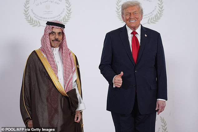 Trump greets Saudi Arabia's Foreign Minister Prince Faisal bin Farhan Al Saud during a summit on Gaza in Egypt