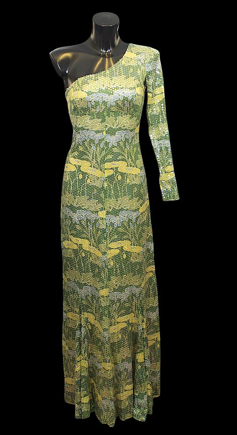 The dress has floral patterned fabric and is embellished with tiny sequins