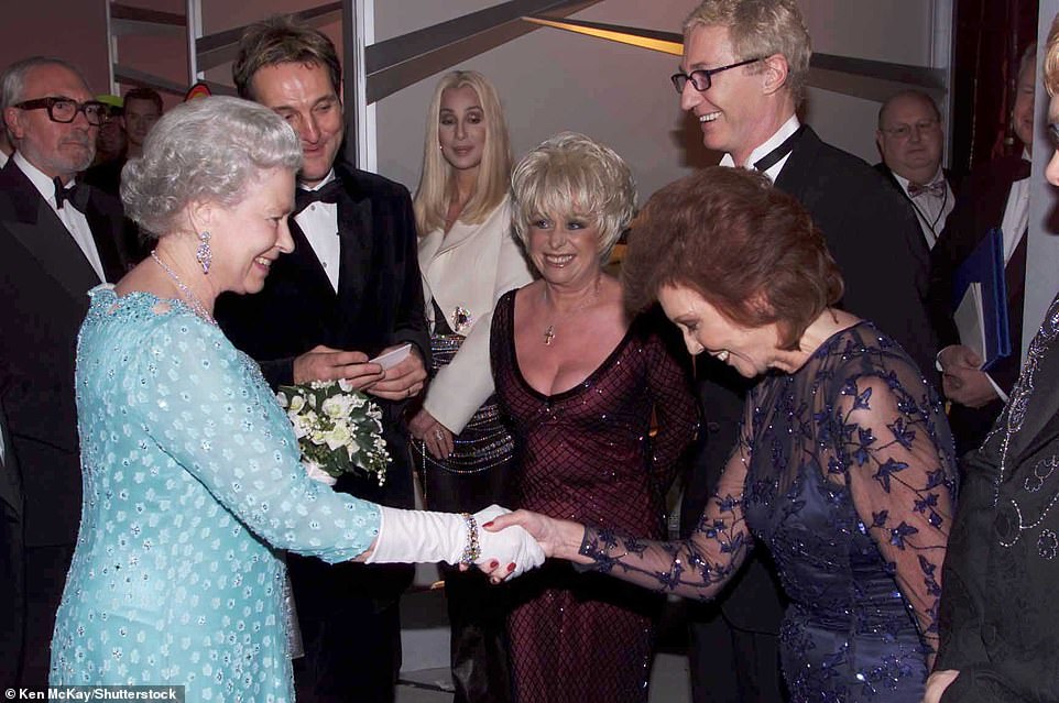 Cilla shakes hands with Queen Elizabeth II at the Royal Variety Performance in London on November 26, 2001
