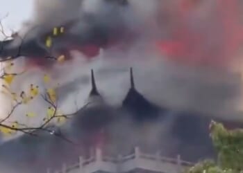 Tragic moment huge blaze engulfs temple after 'irresponsible' tourist is blamed for wrongly using a candle