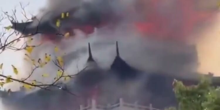 Tragic moment huge blaze engulfs temple after 'irresponsible' tourist is blamed for wrongly using a candle