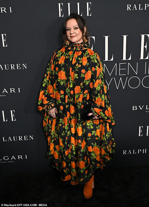 Melissa McCarthy, 55, was a bright vision in a flowing floral gown with pops of orange, green and black