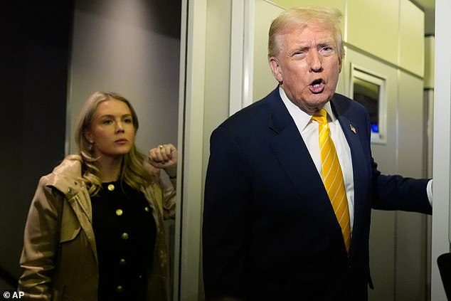 President Donald Trump speaks to reporters on Air Force One on his way to his Mar-a-Lago estate in Palm Beach, Florida