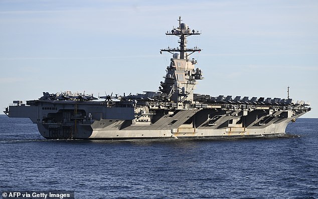 The presence of the USS Ford (pictured) in international waters has experts concerned that a full-blown military confrontation could be approaching