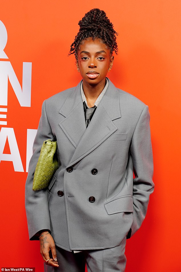 The songstress accessorised with a green woven bag and wore her braids in a high bun