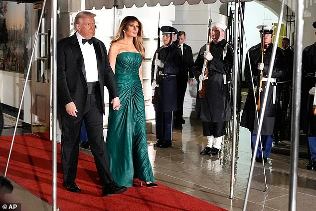 First Lady Melania Trump (right) wore a dramatic emerald strapless dress, which matched the flag of Saudi Arabia