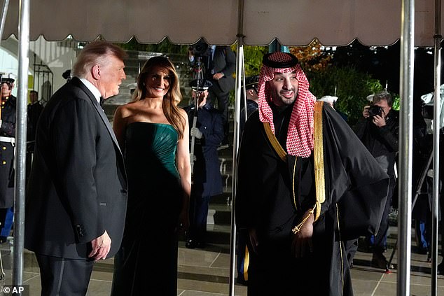 First Lady Melania Trump (center) smiled as President Donald Trump (left) greeted MBS (right) on the South Lawn Tuesday night