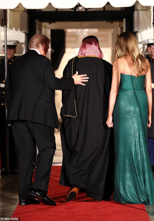 President Donald Trump (left) again put his hand on the back of MBS (center) as he and First Lady Melania Trump (right) escorted the Saudi leader into the White House