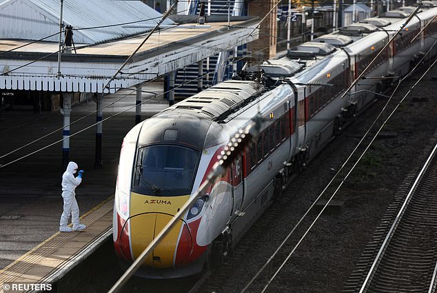 A forensic officer inspects the London North Eastern Railway (LNER) train after the incident