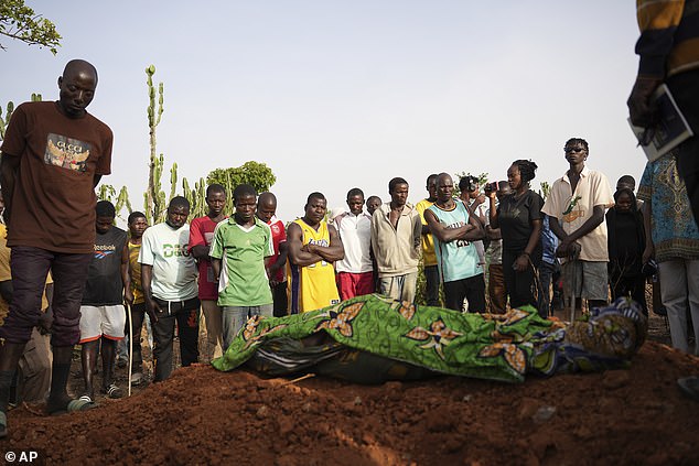 People gather for the funeral of a man who was killed following an attack by gunmen in Zike, north-central Nigeria, in April 2025