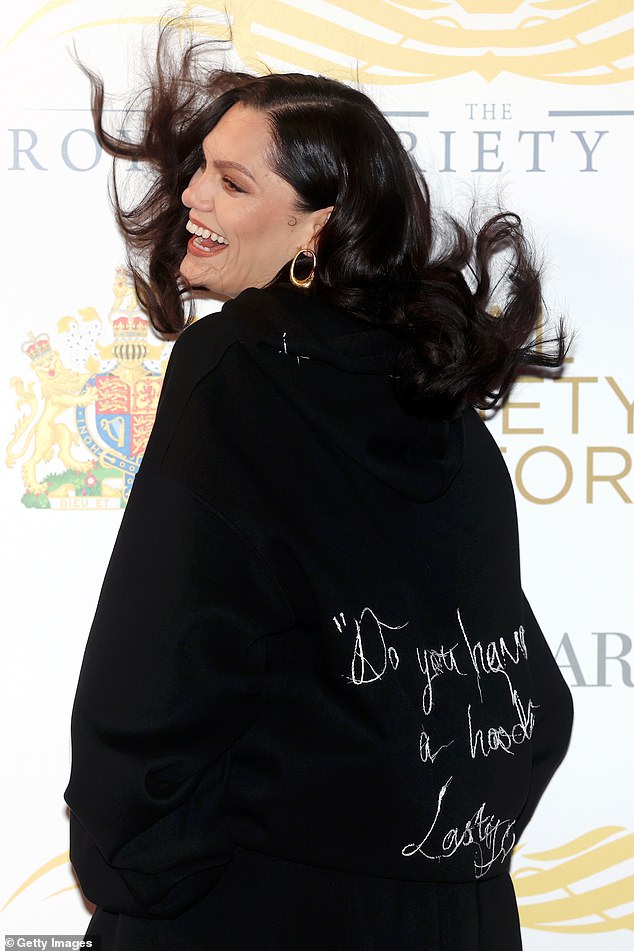 The singer, 37, appeared in great spirits as she beamed while tossing her dark locks and striking a pose