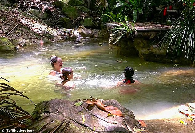 Heading down to the creek with her campmates, she larked around with Alex as they pulled Shona into the water