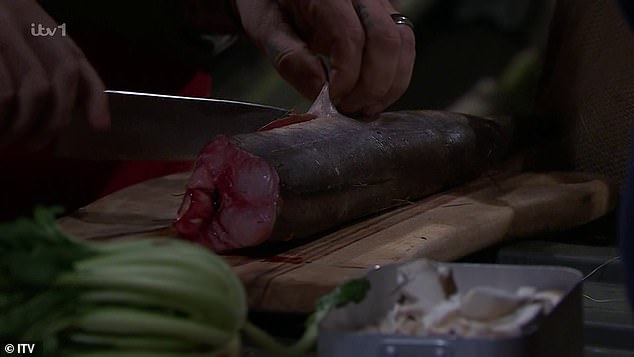 As she asked for help with cooking the eel she then criticised his way of trying to cut it before then taking the task back from him and then gagging over the smell