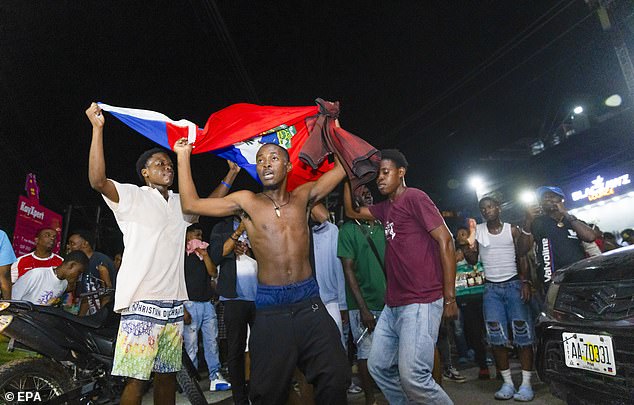 Haiti fans on the streets of Port Au Prince celebrate their country's historic qualification