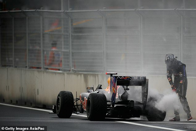 N/A. Mokpo: Sebastian Vettel puts out a fire in his car in South Korea's debut race of 2010 - it was an omen of things to come