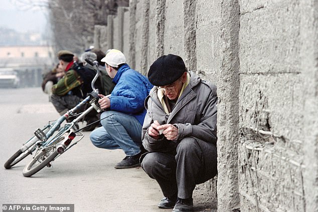 Sarajevo residents keep close to a wall trying to avoid snipers and mortars in 1993 in the besieged capital as fighting intensified