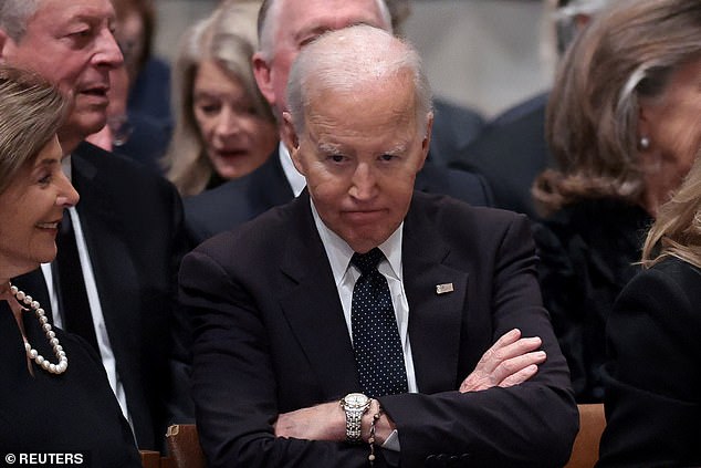 Former President Joe Biden, who turns 83 today, sits with his arms crossed at the funeral services of Vice President Dick Cheney