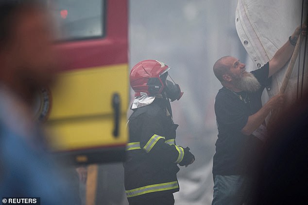 The fire, which officials have said have so far not hurt anyone, tore through an area of pavilions where sideline events are held during the talks