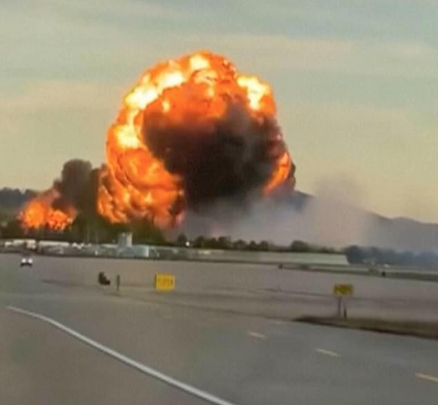 A massive plume of fiery smoke is seen in the air after the devastating plane crash