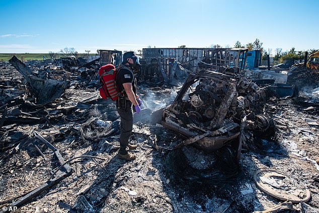 A member of the US Air National Guard is seen surveying the horrible damage left behind from the crash on November 5