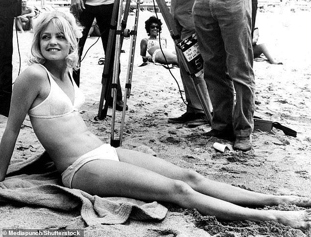 When it comes to maintaining her stunning figure, Goldie does trampolining, yoga, weights and strolls–to boost her mood (pictured in 1979)