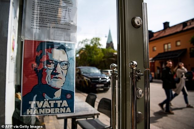 Masks were never mandatory at any point. But they were recommended on public transport at stages. Pictured, posters of Dr Tegnell displayed outside a restaurant in Stockholm in May 2020