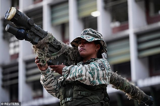 A member of the Bolivarian Militia holds a weapon during a rally amid rising tensions with the United States, in Caracas, Venezuela, October 30