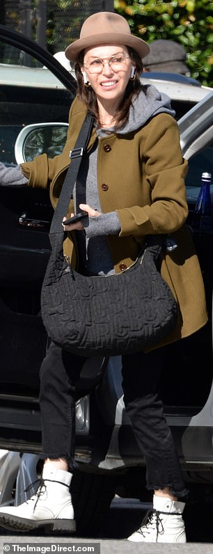 She ran errands with a textured black bag slung across her body