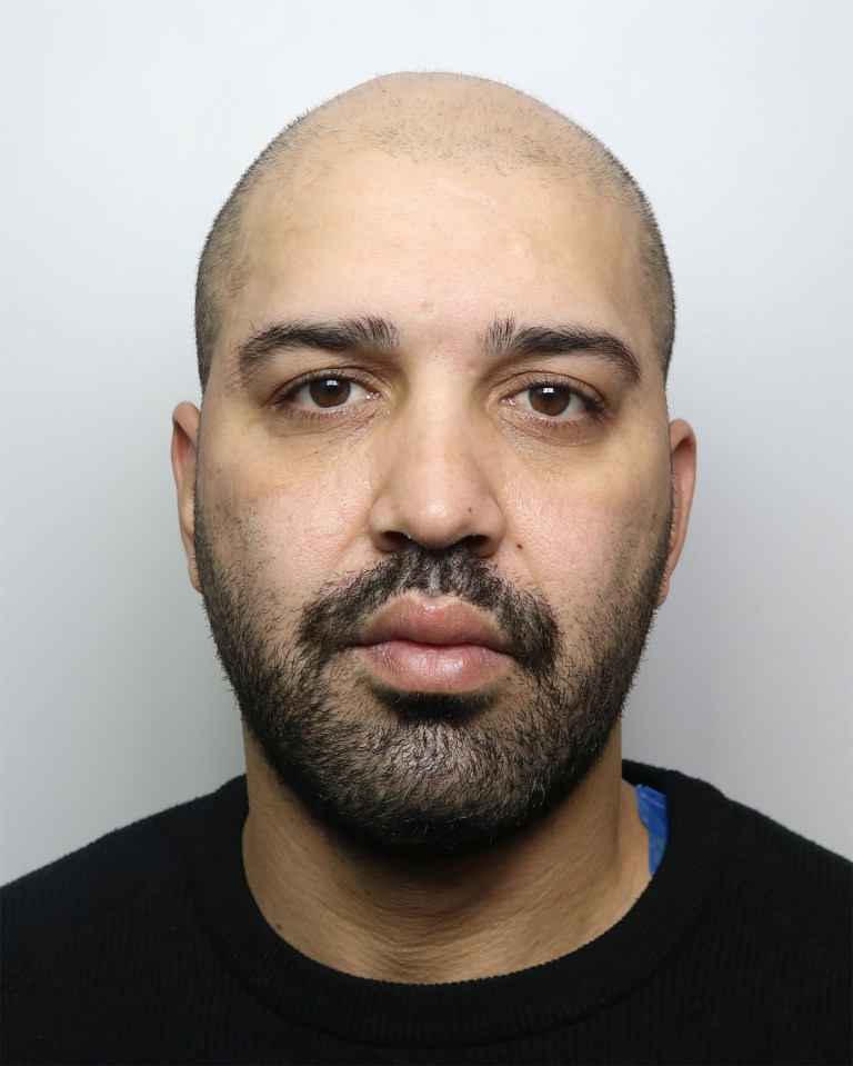 Mugshot of Amin Abedi Mofrad, a bald man with a dark beard and mustache, wearing a black top.