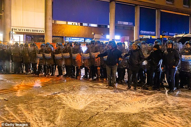 Riot police clash with pro-Palestinian supporters marching towards the Virtus Arena on November 21, 2025