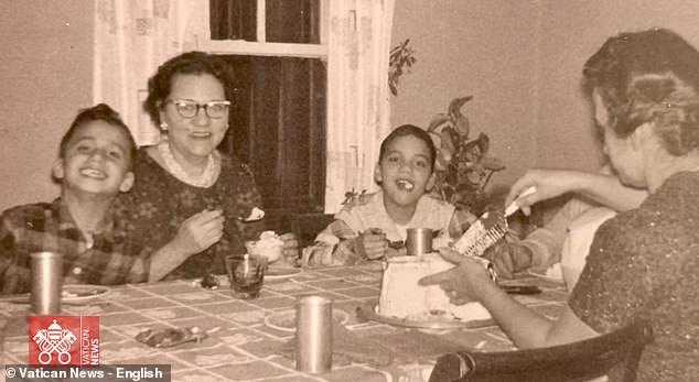 In this undated photo, Pope Leo XIV (then Robert Prevost) (left) smiles while his mother (back to the camera) cuts a birthday cake in what his brother (right) guessed was the pope¿s 9th birthday, at the family home in the Chicago suburb of Dolton