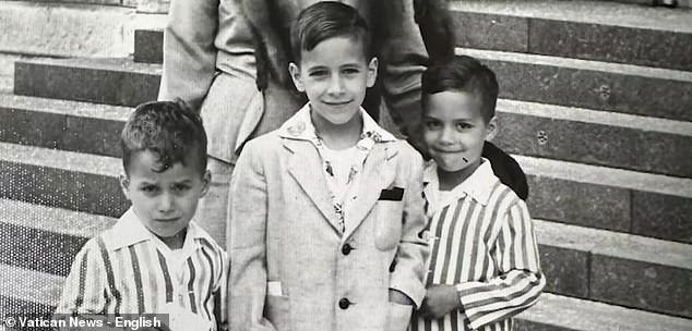 According to John, his younger brother used to convert the ironing board in the basement into a makeshift altar. Pictured: Robert Prevost, left, and his brothers John and Louis