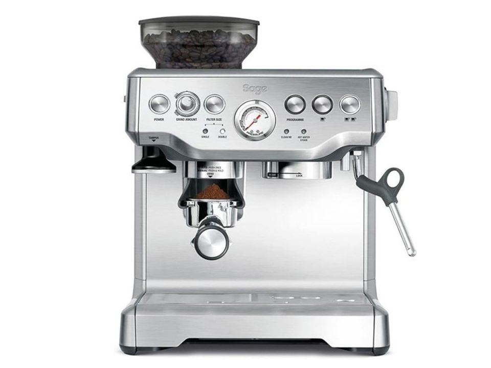 Sage espresso machine with coffee beans in the hopper.