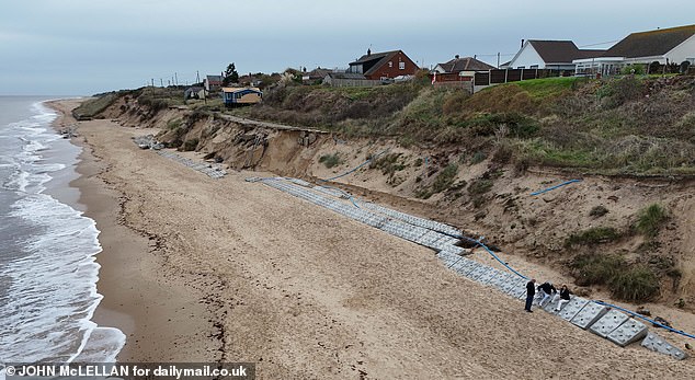Pictured: Fakes Roads residents laying down makeshift sea defences