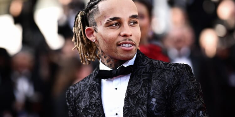 Rapper, 26, who 'kidnapped and beat teen fan who tried to take a photo of him' charged after cops raided star's home