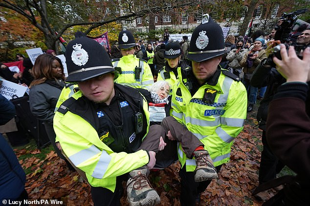 Many protesters were carried out of the square, with one woman's feet dragging on the ground as two officers carried her away