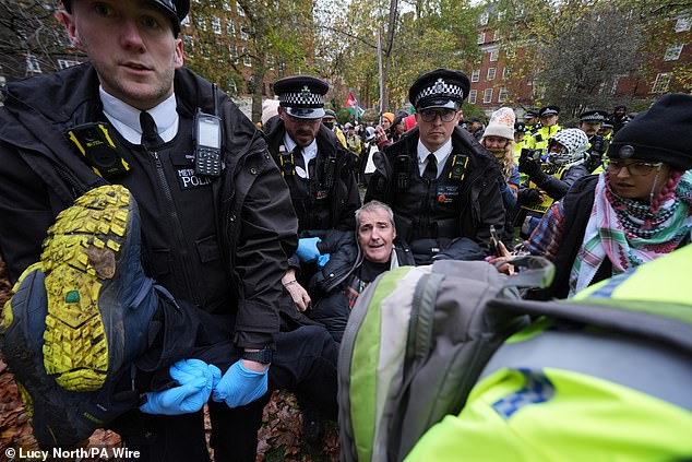 Police remove people from the Defend Our Juries protest in support of Palestine Action at The Peace Garden, Tavistock Square, central London