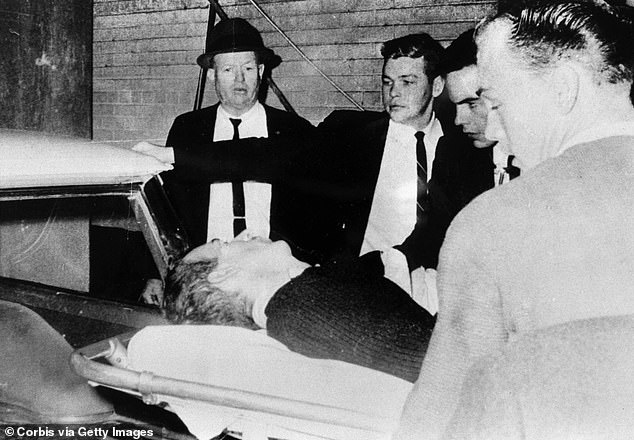 Oswald is carried into an ambulance on November 24, 1963. He was shot by Jack Ruby just two days after the Kennedy assassination