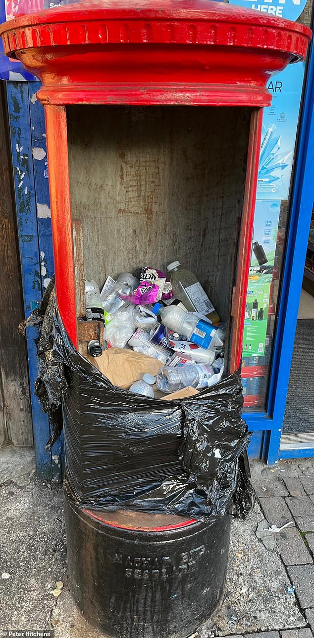 The Oxford old-fashioned Royal Mail pillar box turned into a filthy litter bin by passers-by