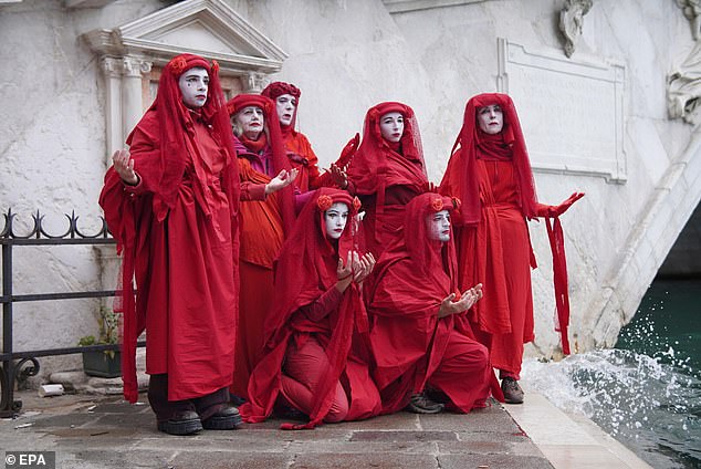 Demonstrators wore full red with veils while slowly walking through crowds of tourists