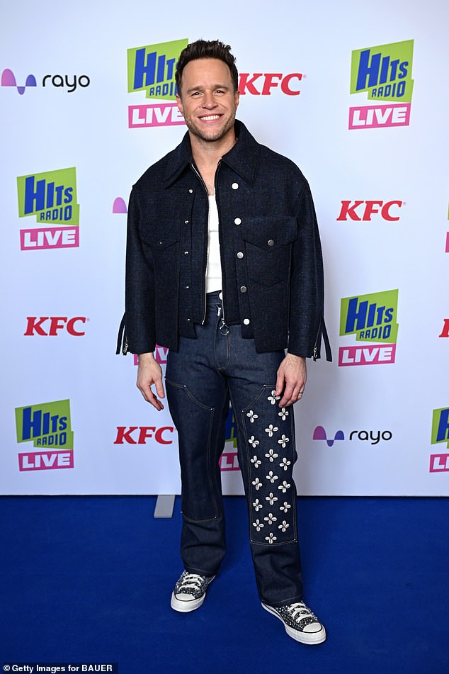 Meanwhile Olly, 41, opted for a dark blue denim jacket and faded jeans as he flashed a smile for the cameras