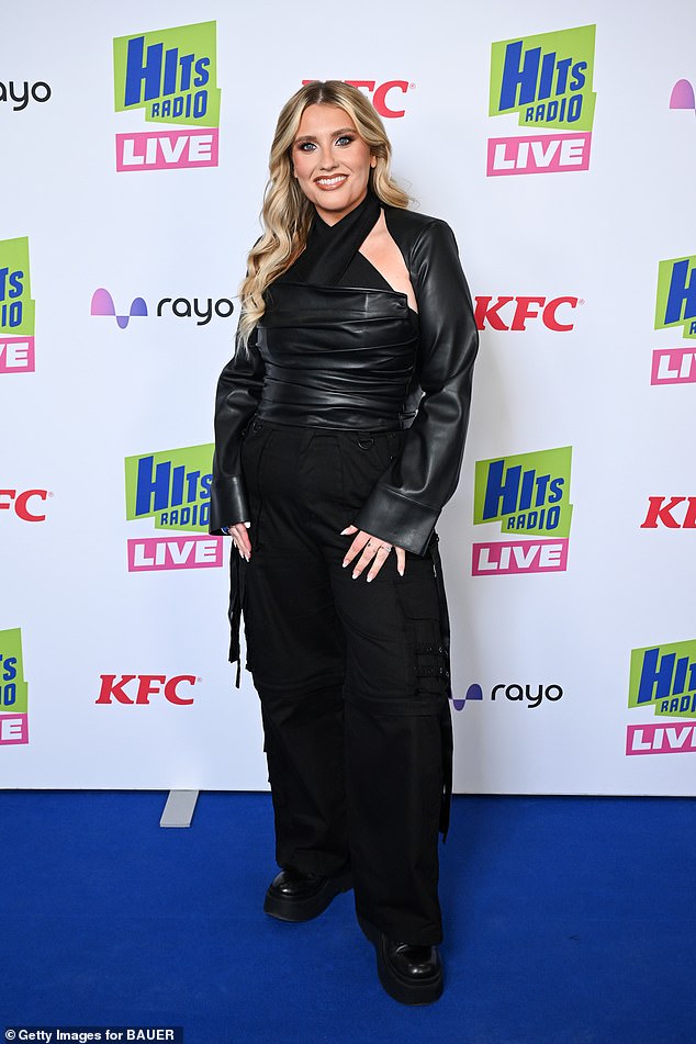 Ella, 29, stunned in a black leather halterneck top with detachable sleeves and matching trousers