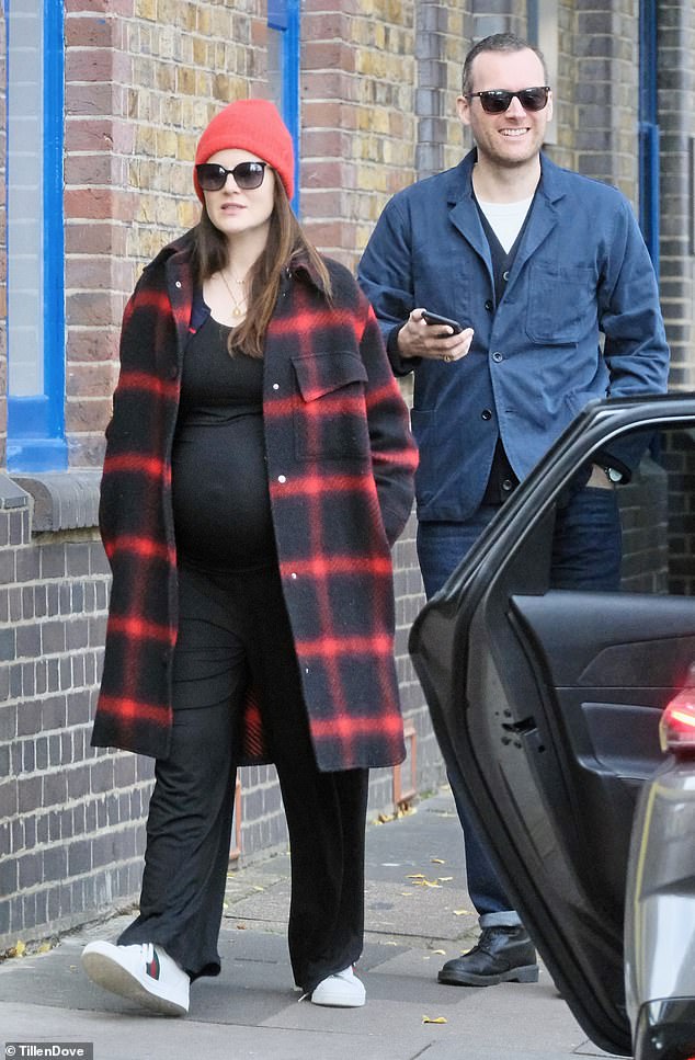 Downton Abbey star Michelle Dockery with her blossoming baby bump as she headed out on a cosy lunch date with her husband Jasper Waller-Bridge, at the River Cafe in Hammersmith